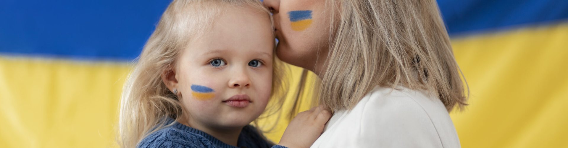 medium-shot-ukranian-mother-kissing-kid